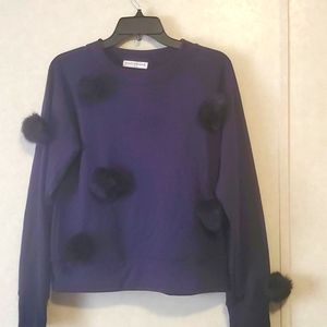 sweatshirt with fur balls.
